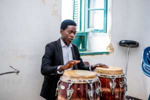 A DCMA student learns to play the drum