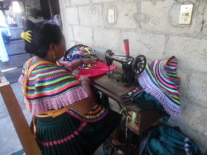Woman sewing on pedal machine