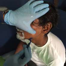 Volunteer providing assistance at shaving station