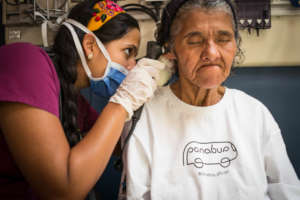 Elderly woman receiving medical care after years