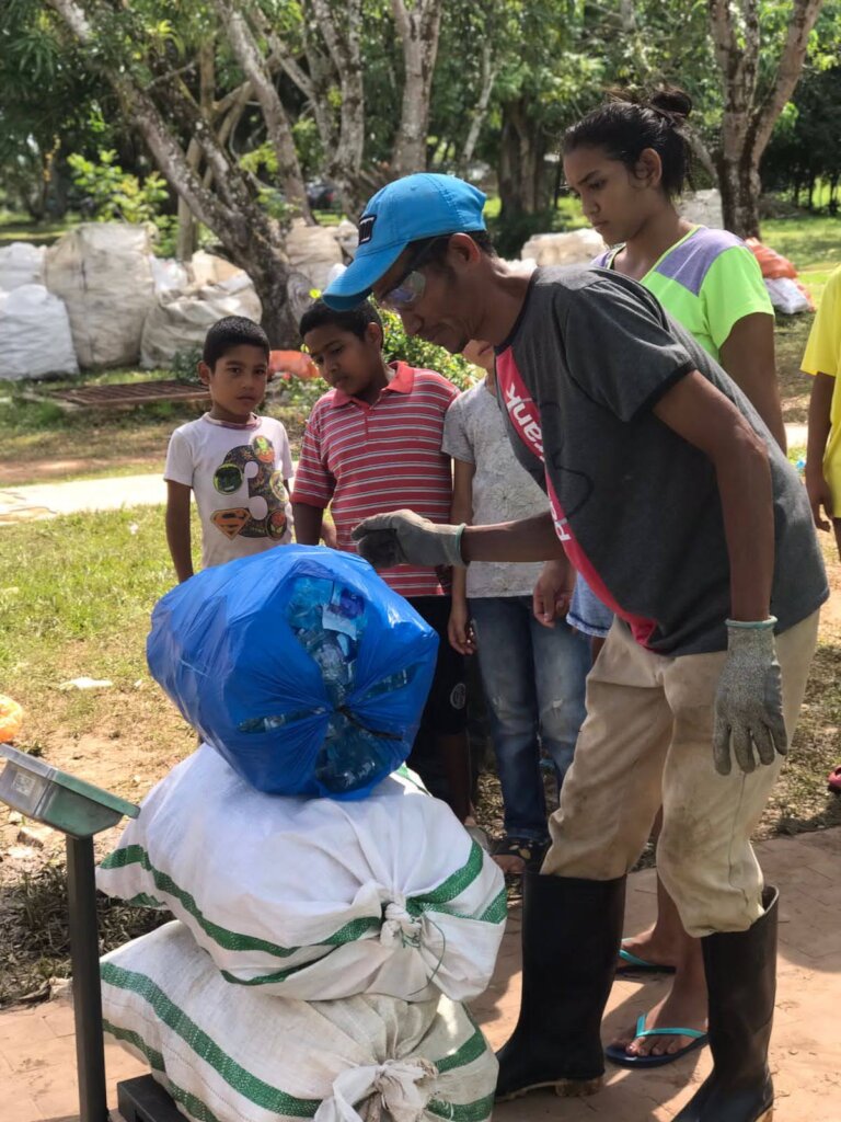 Community member bringing plastic