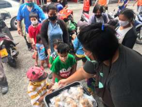Handing out cookies to the children