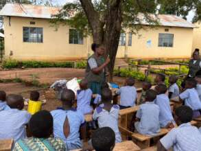 Teammates guiding children to roleplay
