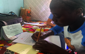 Chipule signing her name for the first time!