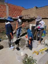 Alejandra, Angela and two helpers mix the concrete
