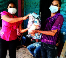 Leader in Tule, Honduras distributes food rations.