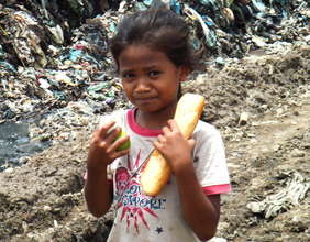 On the Garbage Dump - Girl Recieves Food