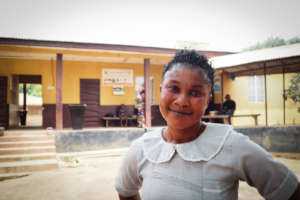 Asha outside Kagbere Health Centre