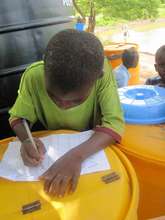 Boy helping us monitor water sales in Gidanturu