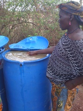 Amina treating dugout water with Alum in Gbong