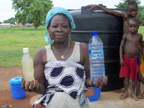 Abiba Fusheni holding the dugout water on the left