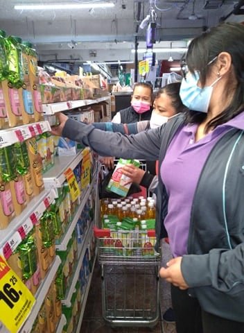 Our staff shopping for home food baskets