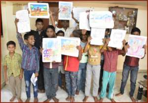 Children displaying their paintings