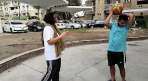 Athlete learning basketball handling with mother