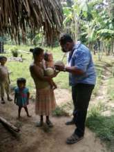 Don Armando distributing melons to local families