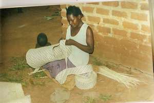 Mrs Kambuga making a mat.