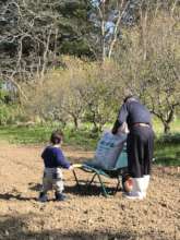 An skilled farmer and a child enjoying farming!