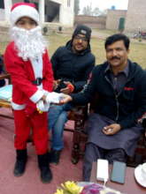 Child as Santa Clause giving sweets to guests