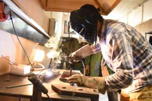 A young man busy at work in the Metal Workshop