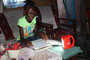 Joy studying at night with her new solar light