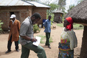 TanzSolar staff working with homeowner