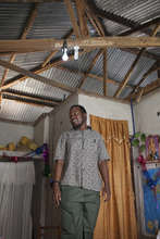 Justin Ibrahim showing the solar lights in a home.