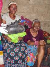 Blind granny of orphan student receiving food aid