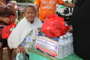 A helpless elderly joyful after receiving goods