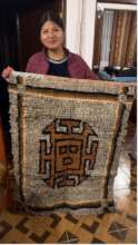 Noelia stops by to show a rug made by her mother.