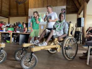 Hassan receiving his Kyaninga Mobility wheelchair