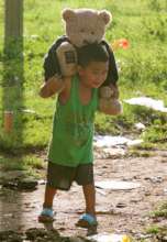 Survivor child carries a friend to safety