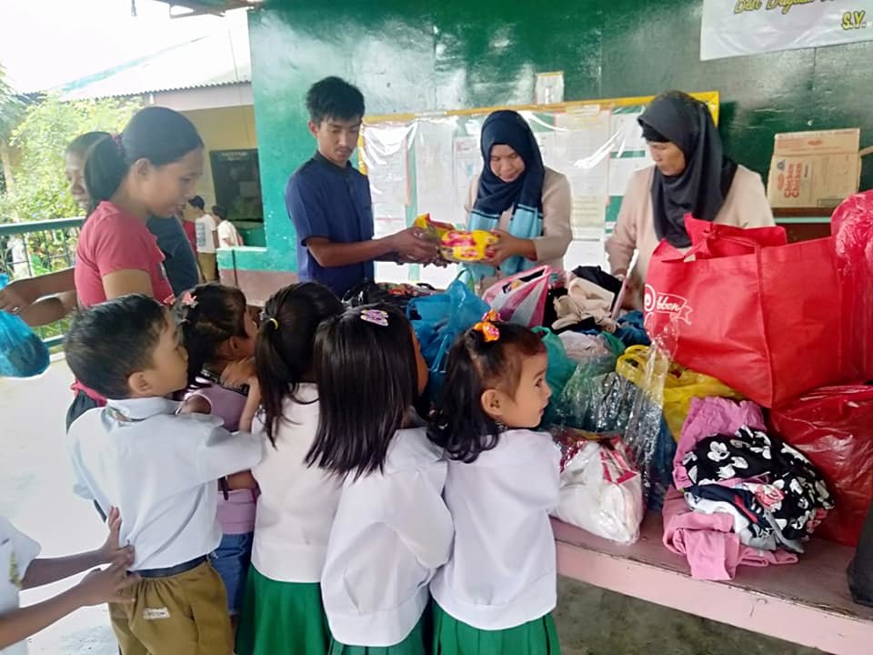 Children receiving supplies pre Covid-19