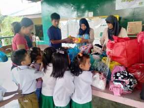 Children receiving supplies pre Covid-19