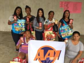 Mothers with donated food to feed their families