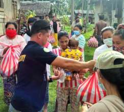 AAI volunteer giving care packages to families
