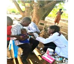 A child recieving malaria test and treatment