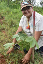 Community member and producer, planting tree