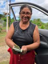 Community member receiving payment for production