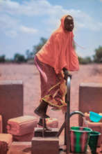 Young girl at well