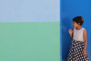 A refugee girl from Iraq waits for her relief kit.