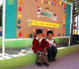 Happy boys sit outside the center