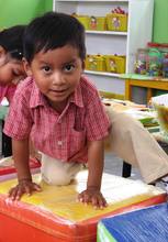 A boy who´s been left behind plays at the center