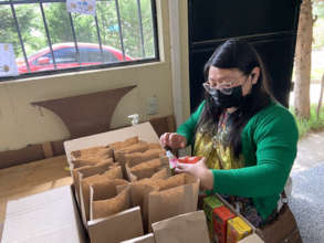 Teresa prepares kits for guests at our open house