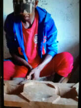 Dah explaining his improved cookstove model