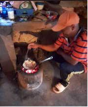 Cooking a meal for his family improved cookstove