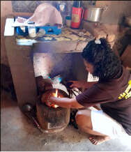 Our midwife cooking with her improved cookstove