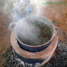 Using the improved cookstove to make moringa tea