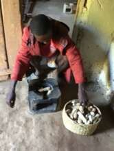 Jean Liva using corn cobs to cook