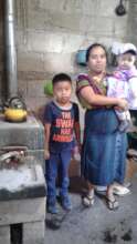 Andreas with her children in front of the stove