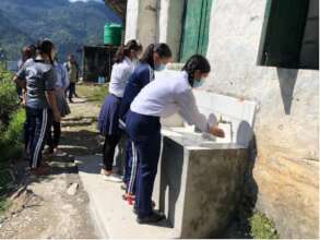 Young girls using the WASH facilities at school